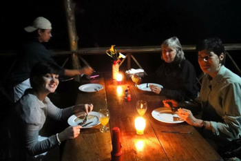 Dinner of volunteers, by candlelight.