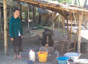 A Lao woman offering samples of her lao khao (rice whiskey)