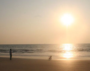 A child with her father at the beach