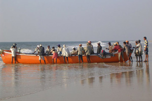 Fishermen launching a boat