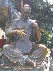 A statue of a cossack playing a pandora, a Ukrainian stringed instrument