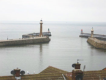 Whitby's West Pier and its 75 foot high lighthouse looking out from the River Esk to the North Sea