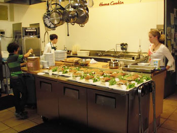 Members of the Reddekopp family preparing a meal in the kitchen