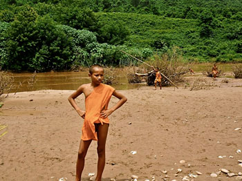 Young monks play by the riverside.