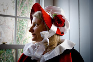 This roving caroler made her own hat and floor-length cape in Dickens-era fashion.