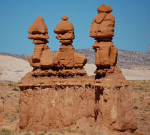 Three goblins stand together like greeters, welcoming visitors.