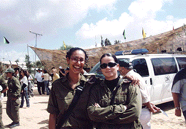 Army girls smiling while on duty in Jerusalem.