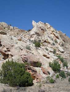 The Earth has lifted layers of ancient rock up to a steep angle along the road to the dinosaur bones.