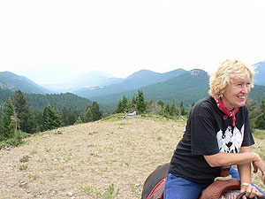 Atop a mountain with smoke from the forest fires visible in the distance.