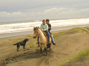 The author is assisted by a gaucho on the beach in Chiloe, Chile. Photos by Paola Fornari