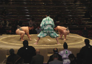 The gyoji (referee) prepares for the start of another sumo wrestling bout.