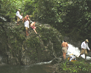 Climbing up a waterfall to enjoy a plunge in a jungle pool.