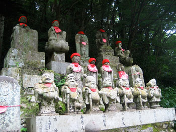 Statues along the trail. Local people take care of the statues and protect them from the elements by putting hats and bibs on them. The seven figures at the bottom are the seven deities of good luck.