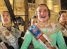 Young ladies of the Fallas community react to the loud explosions that take place just before the Ninot's cremation.