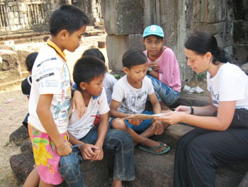 Nicole helps the children with some difficult words.