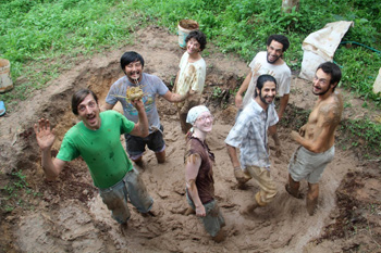 Mixing mud for adobe bricks at the Panya Project in Thailand.