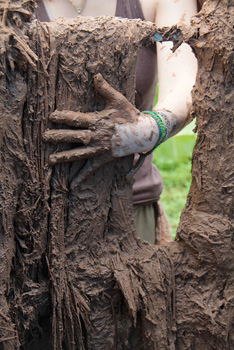 Smoothing the wattle and cob walls