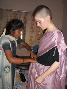 A student from Semester at Sea, is fitted for a sari.