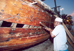 A craftsman repairs a dhow at the Dubai Heritage Village.