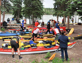 Preparing the canoes as they come in for a mandatory rest stop in Carmacks 