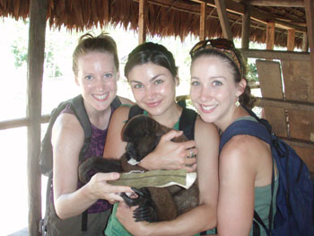 The Lost Girls in Peru holding an Amazon monkey 
