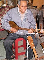 Elderly musician playing in a Chiang Mai club.