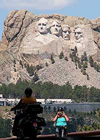 Bikers pose in front of Mt. Rushmore - photo by David Rich
