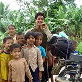 Motorcyclist with some local kids in Vietnam.