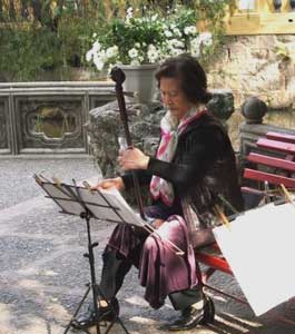 A woman plays a Chinese two-string fiddle known as an ehru in the park in Macau. Photos by Kent E. St. John