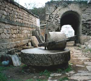Hiking Along the Great Wall of China 5 An ancient millstone at the entrance to Yao Zi Yu