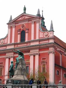 A monument to France Preseren, Slovenia's greatest poet, flanks the vivid Church of the Annunciation at Preseren Square in Ljubljana. Photo by Christine H. O'Toole