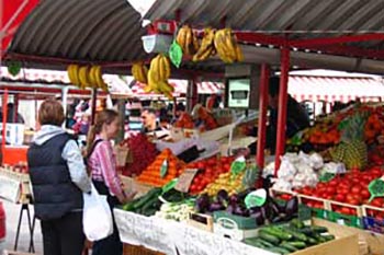 Ljubljana market: Flowers, fresh fruit, and bear sausage tempt the crowds by the Market Colonnade. Photo by Christine H. O'Toole
