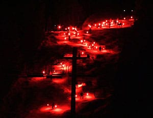 Montana's Wildest Winter Resorts 11 A parade of skiers with torches resembles a flow of red hot lava