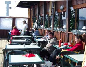 The French Alps: Snowplowing My Way Through 3 Some hearty souls brave a brisk wind to enjoy a meal deckside at Le Signal overlooking the mountains.