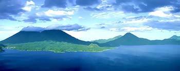 Three enormous volcanos form the lake's southern shore. Atitlan, Toliman and San Pedro. Lake Atitlan Guatemala