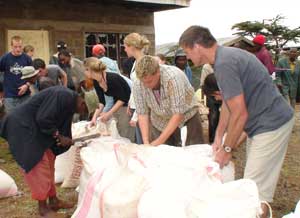 Volunteering in Kenya: From the Safari to the Relief Station 3 Mark helps distribute food to waiting villagers.