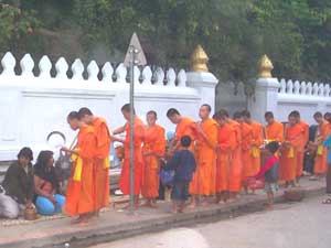 A daily ritual in Luang Prabang: monks receiving offerings from the faithful - photos by S. Michael Scadron