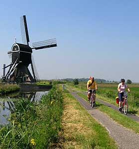 A Netherlands Bike and Boat Adventure 5 Biking by a windmill