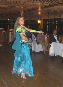 A belly dancer entertains the passengers.