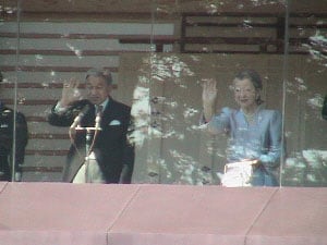 The emperor and the empress wave to the crowds.