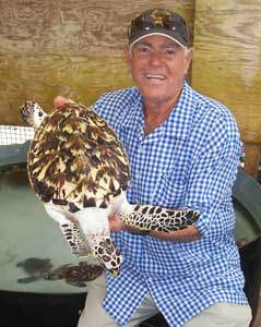 Orton “Brother” King introduces one of the soon to be released hawksbill sea turtles raised at his Oldhegg Turtle Sanctuary.