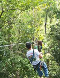 The author's daughter zips through the trees near Tikal.