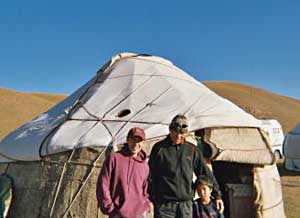 The author, his guide, and a shepherd boy at their yurt on the second day of the hike in the plains of Krygyzstan. 
