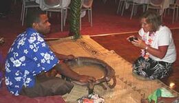 A tribal chief in Fiji shares kava with a visitor.