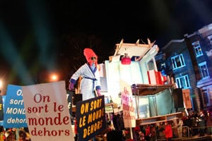 Night Parade, with signs that say "go outside in the winter!"