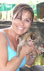 Theresa Rodriguez Williamson with a monkey in Thailand