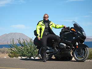 The author by the sapphire blue Sea of Cortez, motorcycle Baja California.