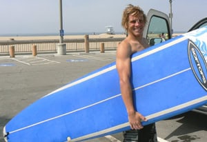 Charlos Bentley, Surf Teacher and resident of Huntington Beach, ready to hit the waves. photos by Max Hartshorne.