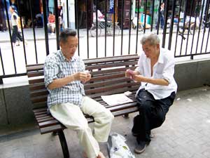 Two men playing cards in the park