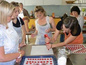 Making macarons, a famous cookie, in a baking class taught all in French in Tours, France.